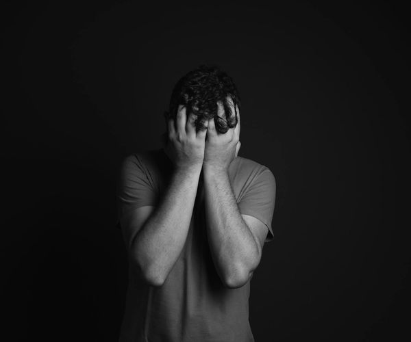 Silhouette of a man stretching against a sunrise, feeling energized.